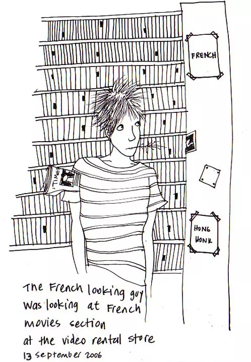 The French looking guy was looking at French movies section at the video rental store