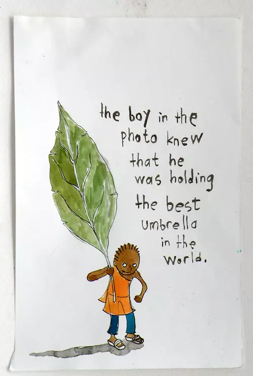 the boy in the photo knew that he was holding the best umbrella in the world. 
