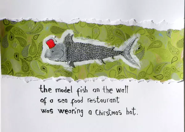 the model fish on the wall of a sea food restaurant was wearing a Christmas hat.